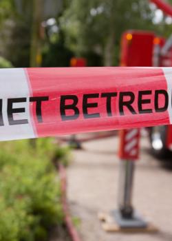 Situatie op straat met een brandweerauto en een rood-wit lint met 'Niet betreden'